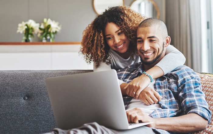 couple using laptop to access greylock online banking from home