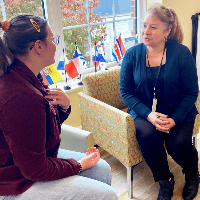 Two women practice speaking Spanish together